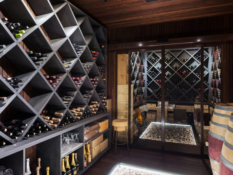 luxury cellar of prestigious house, shelves full of bottles